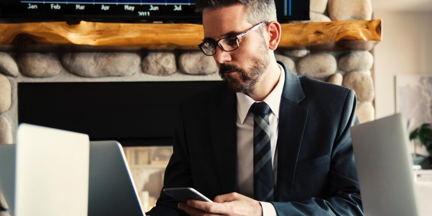 US Federal agent in formal dress trying to access data on a laptop.